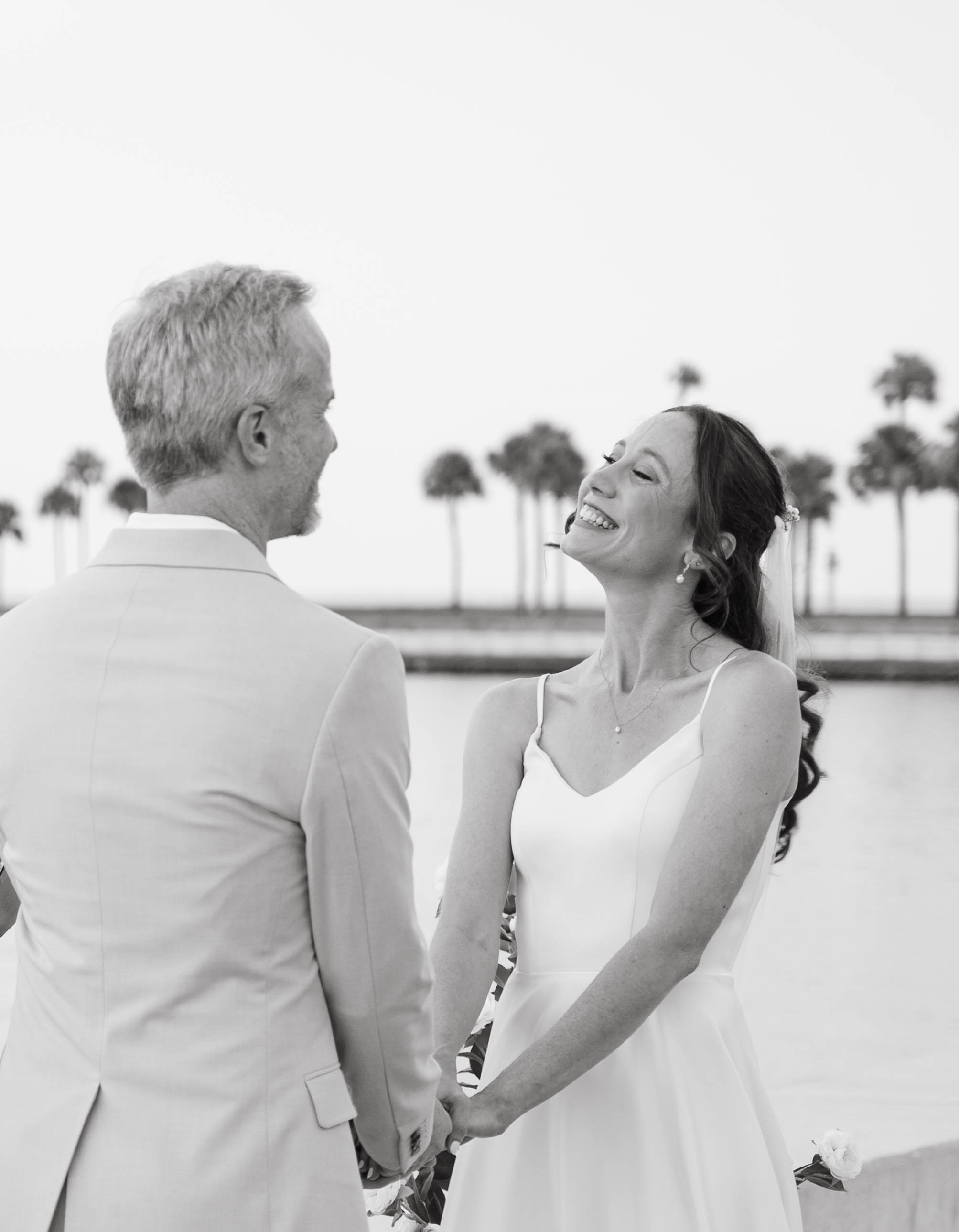 Newlyweds laughing together during their ceremony