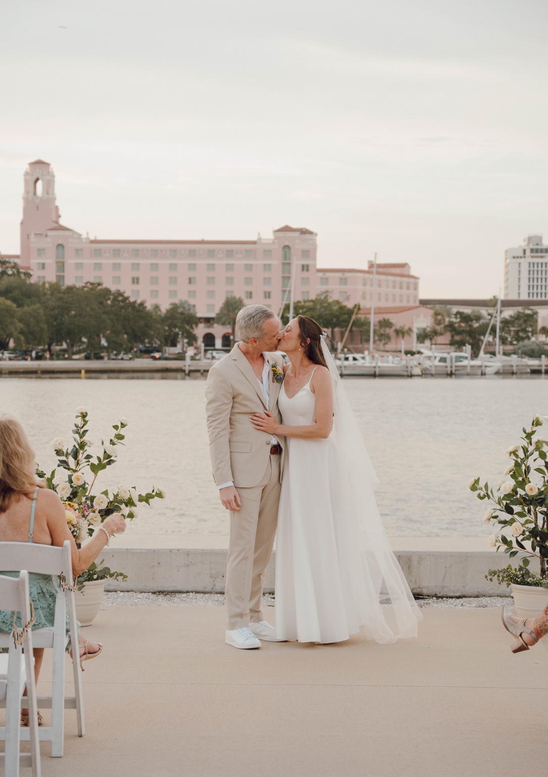 Newlyweds kissing at their waterfront ceremony