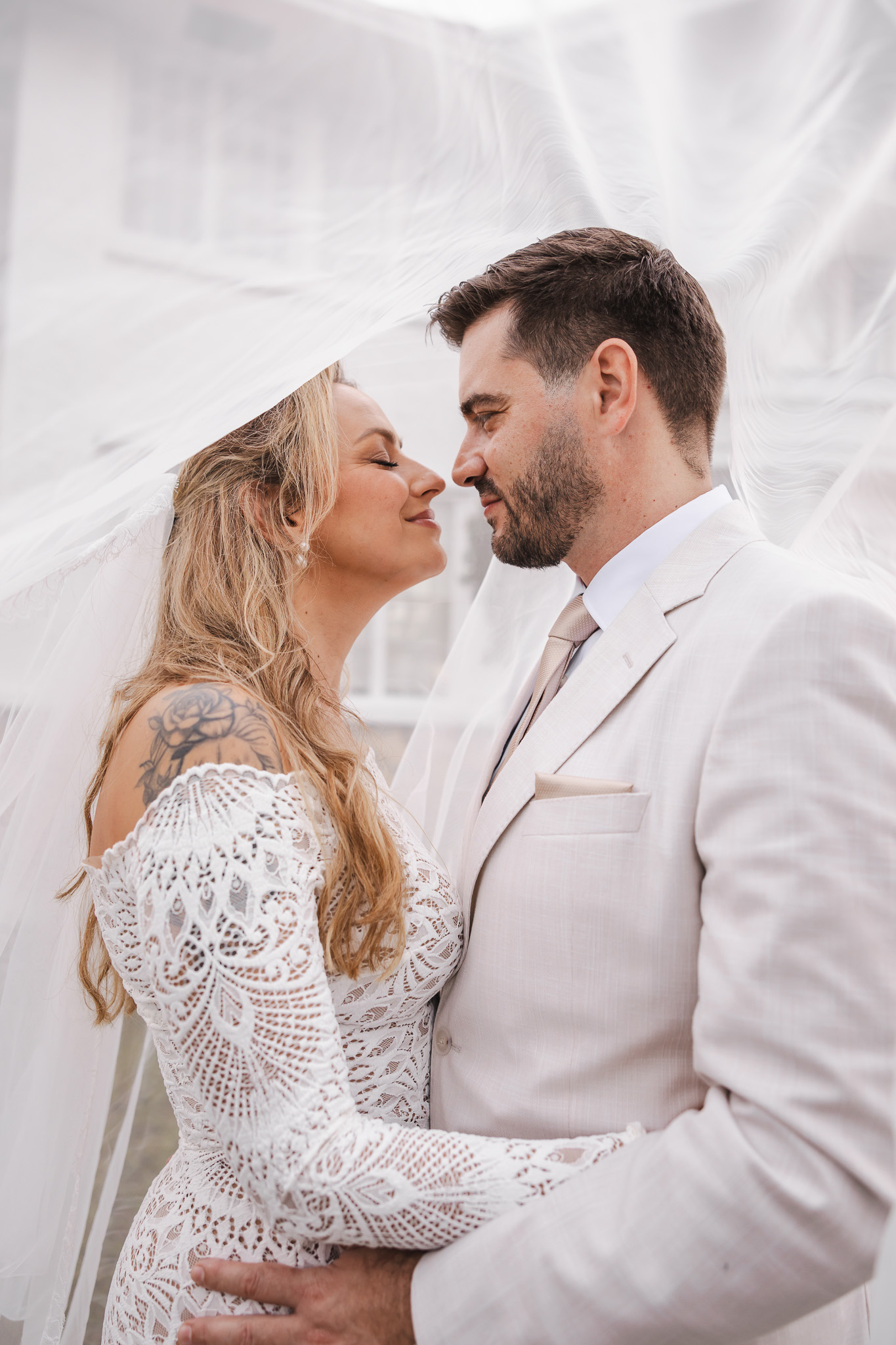 Newlyweds sharing a quiet moment beneath the veil