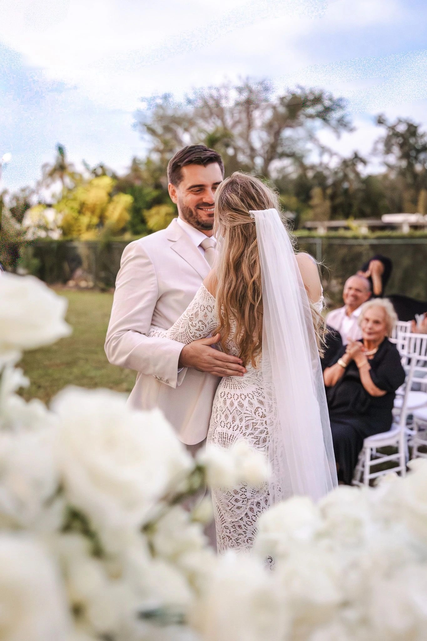 Groom smiling at his bride during their ceremony